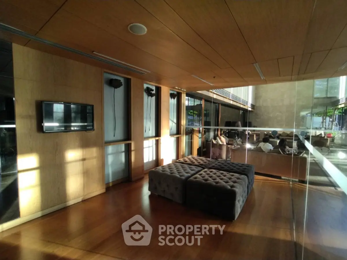 Modern lobby with stylish seating and wooden accents in a contemporary building.