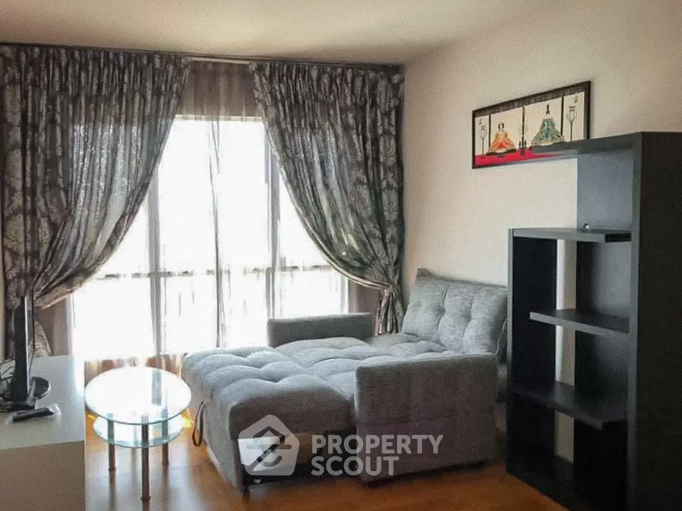 Cozy living room with stylish sofa and elegant curtains, perfect for relaxation.