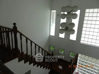 Elegant staircase with modern chandelier in a spacious home interior