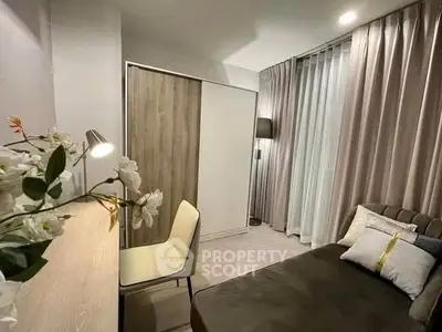 Cozy bedroom with modern decor, featuring a comfortable bed, stylish curtains, and a sleek desk with a chair.