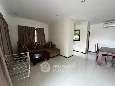 Spacious living room with modern furniture and dining area in open layout