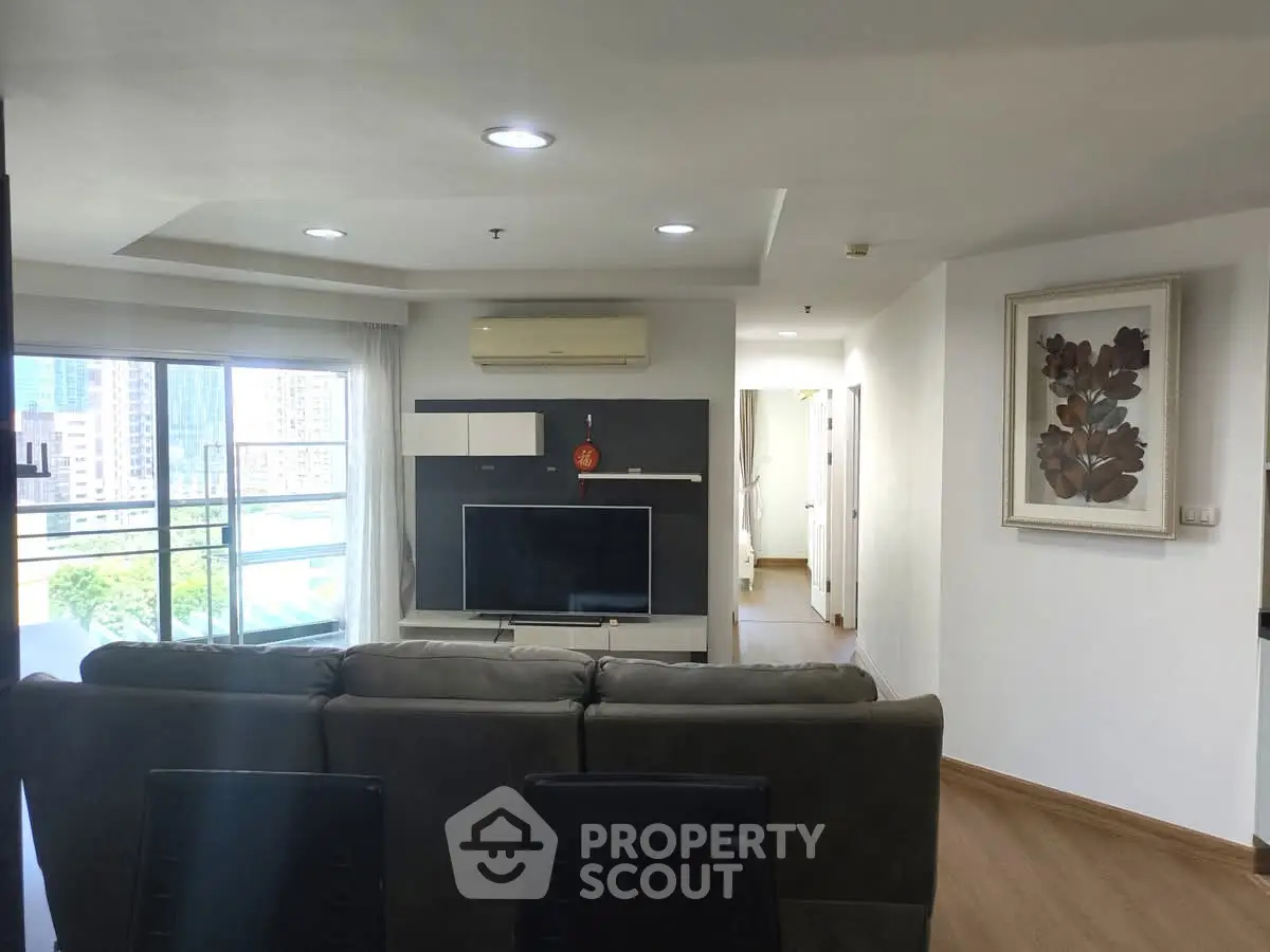 Spacious living room with modern decor and city view, perfect for urban living.