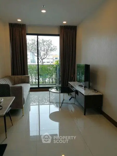 Modern living room with large window and stylish furniture in a cozy apartment.
