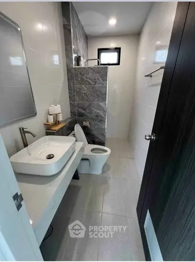 Modern bathroom with sleek design and elegant fixtures in a contemporary home.