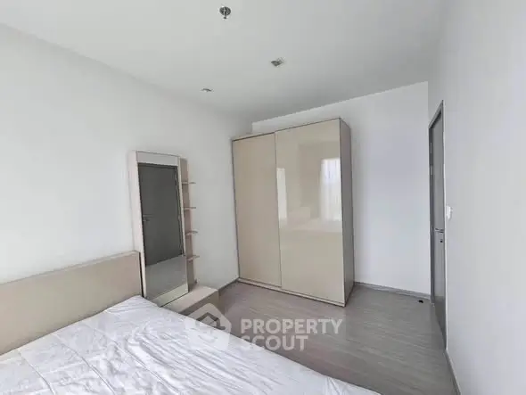 Spacious modern bedroom with sleek wardrobe and minimalist design
