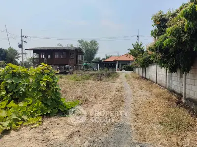 Spacious rural property with traditional wooden house and open land, ideal for development or agriculture.