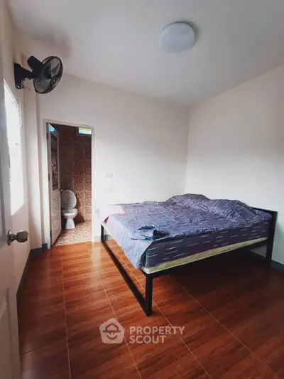 Cozy bedroom with ensuite bathroom and wooden flooring