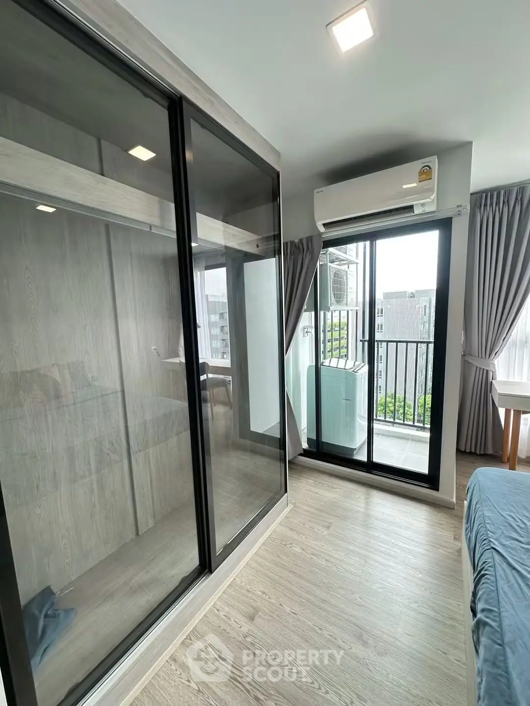 Modern bedroom with balcony access and sleek wardrobe design