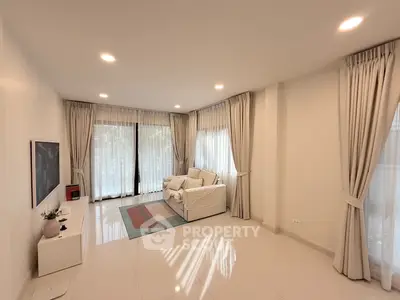 Spacious modern living room with elegant curtains and cozy seating area