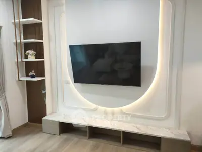 Modern living room with sleek TV setup and elegant shelving
