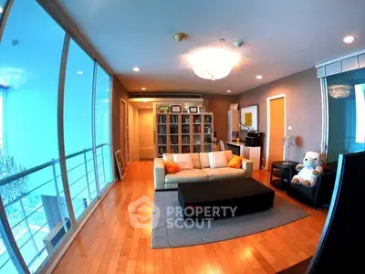 Spacious living room with large windows and elegant decor