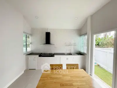 Modern kitchen with sleek design and open layout, featuring gas stove and ample natural light.