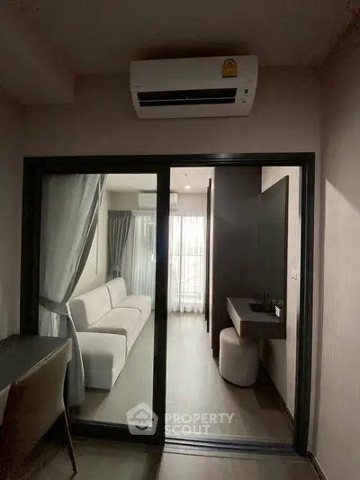 Modern living room with air conditioning and sliding glass doors