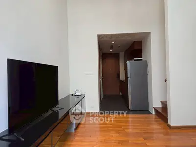 Modern living room with sleek TV setup and wooden flooring