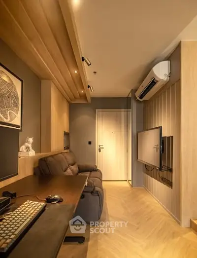 Modern study room with sleek design, featuring a comfortable sofa, wall-mounted TV, and air conditioning.