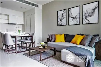 Modern living room with stylish decor and open dining area, featuring contemporary furniture and elegant wall art.