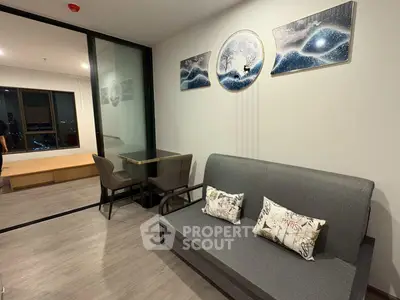 Modern living room with stylish decor and city view, featuring a cozy sofa and elegant dining area.