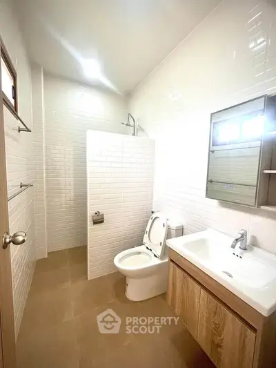 Modern bathroom with sleek fixtures and white tile accents