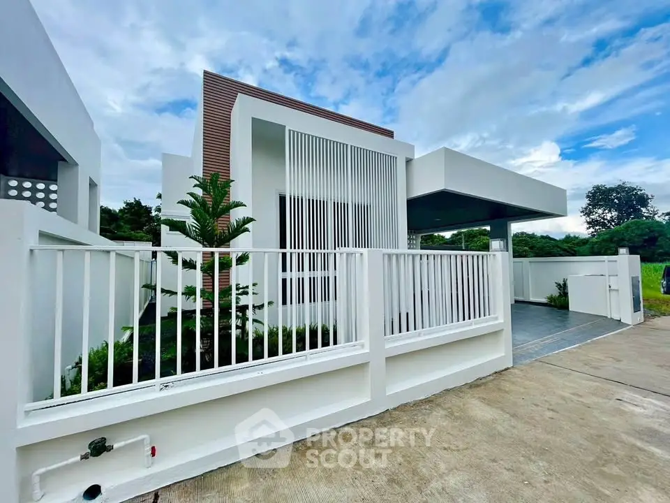 Modern minimalist house exterior with sleek design and spacious driveway, perfect for contemporary living.