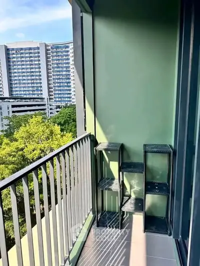 Spacious balcony with city view and green accents, perfect for relaxation.