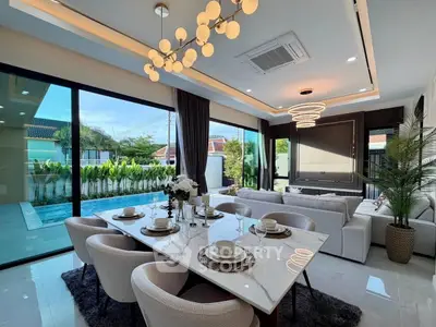 Luxurious open-plan living room with pool view and elegant dining area