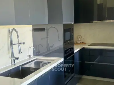 Modern kitchen with sleek cabinetry, built-in appliances, and elegant fixtures.