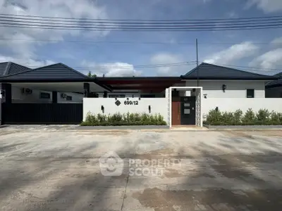 Modern single-story house with sleek design and gated entrance, perfect for contemporary living.