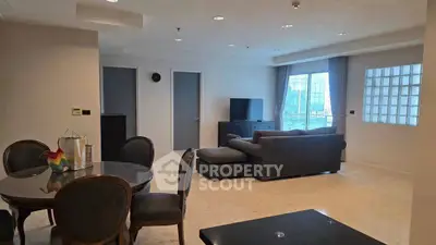 Spacious living room with elegant dining area and large windows for natural light.