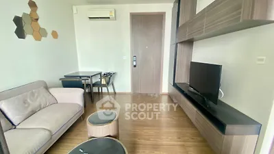 Modern living room with sleek furniture and wooden flooring in a stylish apartment.