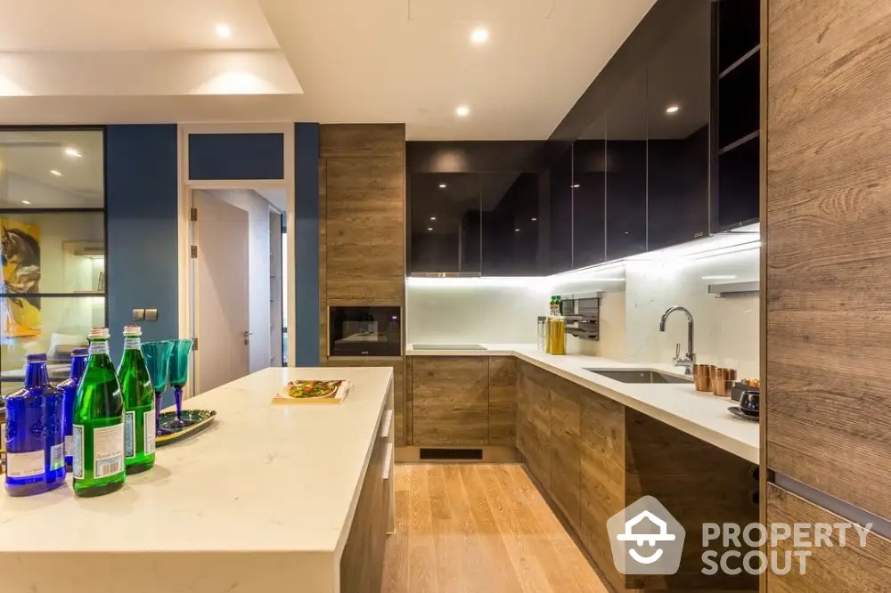 Modern kitchen with sleek cabinetry and marble countertops in luxury apartment