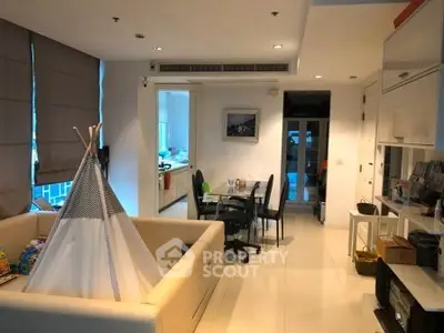 Spacious living room with modern decor and play tent, ideal for family gatherings.
