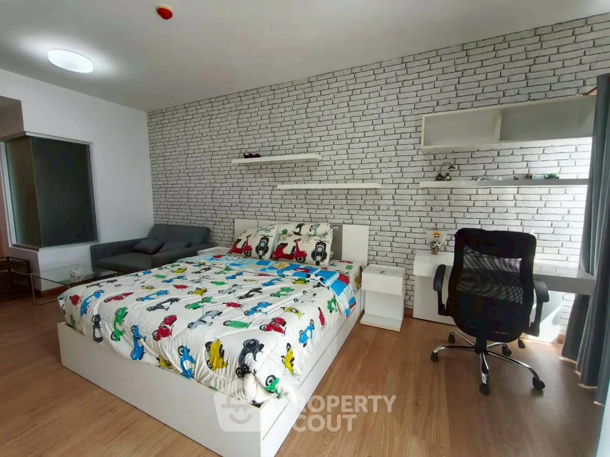 Modern bedroom with stylish brick accent wall and cozy seating area