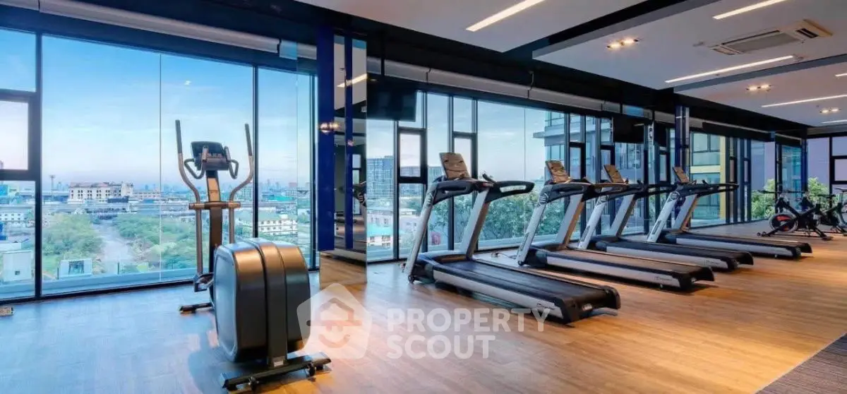 Modern gym with panoramic city views and state-of-the-art equipment.