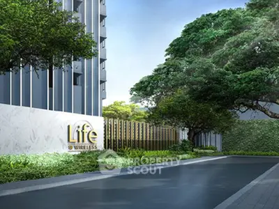 Modern building entrance with lush greenery and sleek design at Life Wireless.