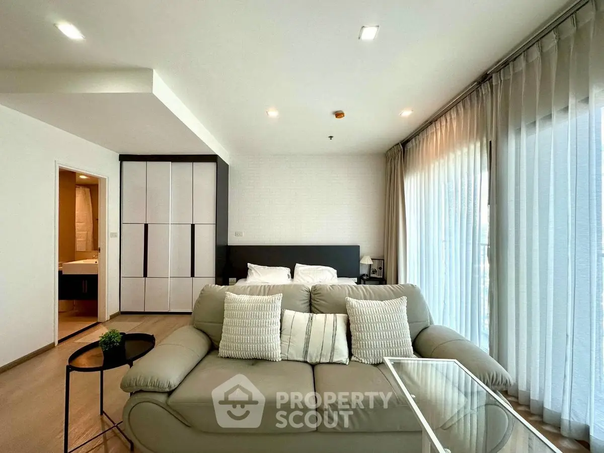 Modern living room with cozy sofa and large windows in a stylish apartment