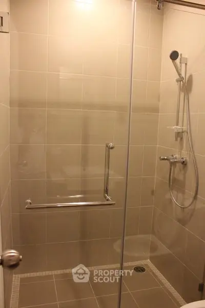 Modern bathroom with sleek glass shower enclosure and contemporary fixtures.