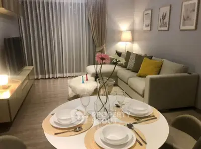 Stylish modern living room with cozy sofa and elegant dining setup