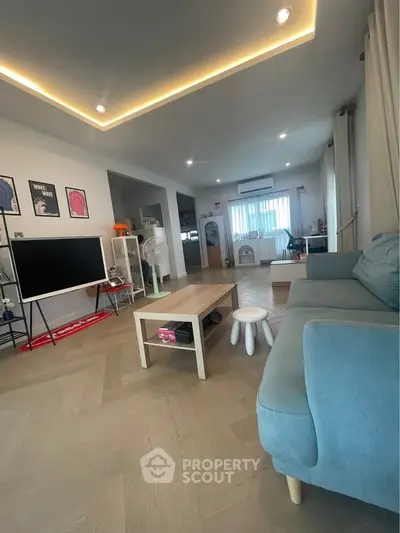 Spacious modern living room with stylish decor and ample natural light.