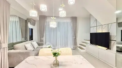 Elegant modern living room with marble accents and cozy lighting