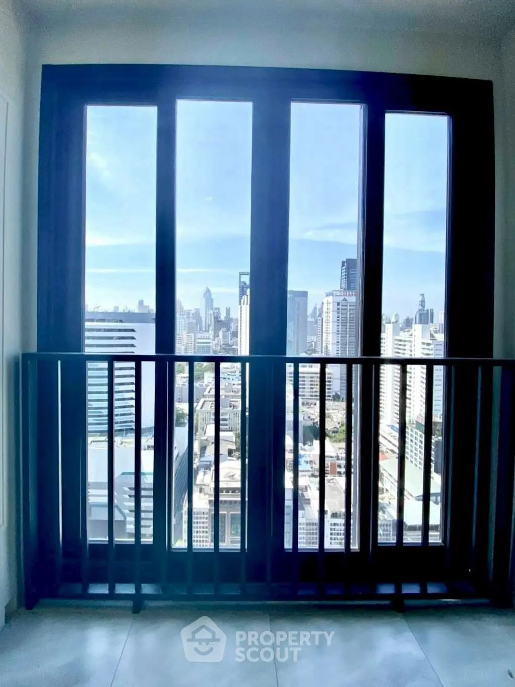 Stunning city view from a high-rise balcony with sleek railing design.