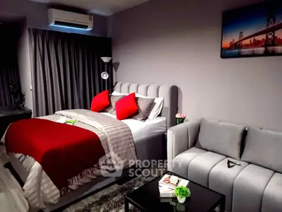 Modern bedroom with stylish decor and cozy seating area, perfect for relaxation and comfort.