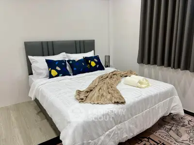 Cozy bedroom with modern decor and plush bedding in a stylish apartment.