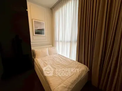 Cozy bedroom with elegant curtains and framed artwork, perfect for relaxation.