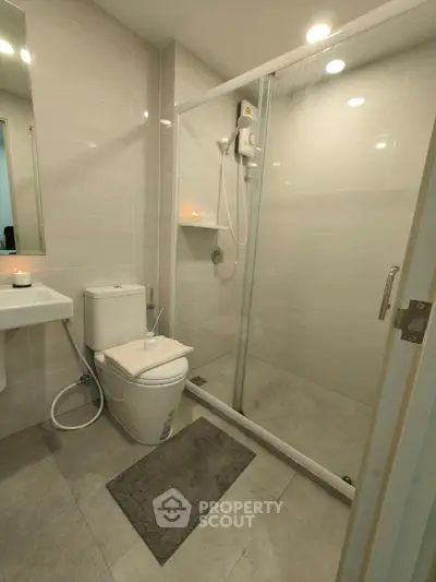 Modern bathroom with glass shower and sleek fixtures, perfect for a contemporary home.