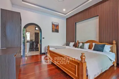 Elegant bedroom with wooden flooring and stylish decor