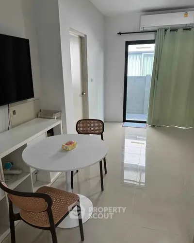 Modern living room with sleek furniture and natural light, perfect for cozy gatherings.