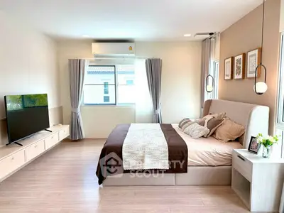 Spacious modern bedroom with stylish decor and natural light