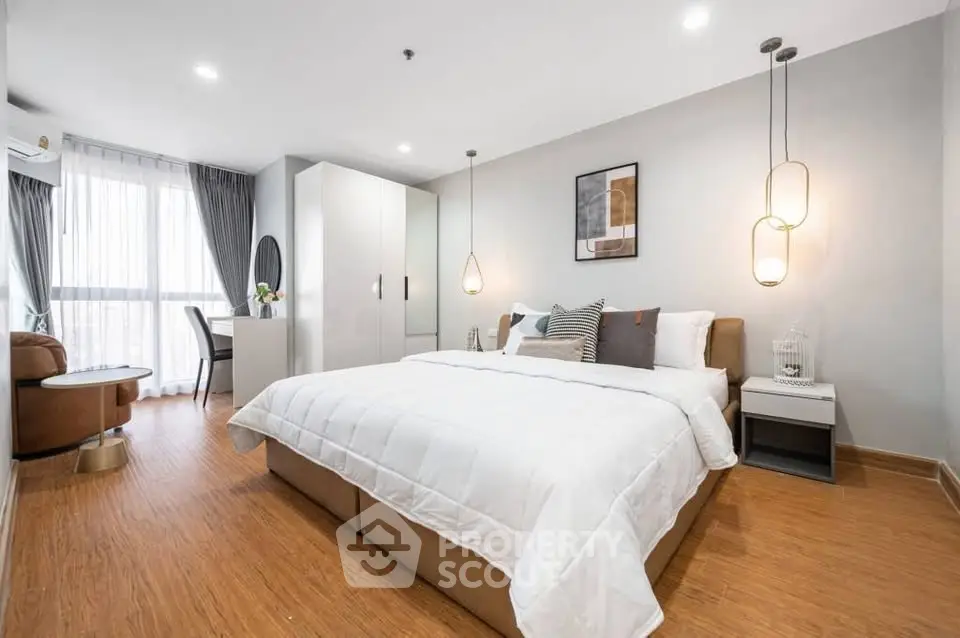 Spacious modern bedroom with elegant decor and natural light
