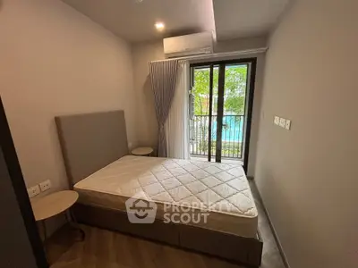 Cozy bedroom with balcony view and modern furnishings in a stylish apartment.