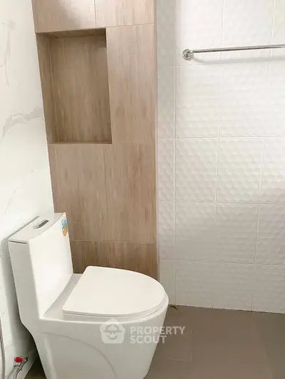 Modern bathroom with stylish tile design and sleek toilet